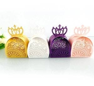 Detail of laser-cut crown gift boxes in pink, purple, white and yellow for weddings