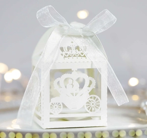 White laser cut pumpkin carriage wedding favor box with elegant crown design and ribbon