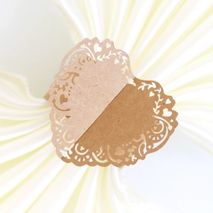 Detail of laser-cut lavender heart paper napkin ring with intricate lace texture