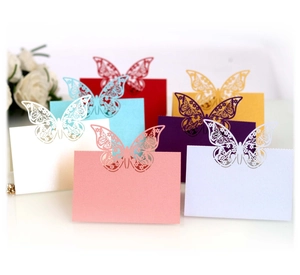 Laser cut butterfly place cards with intricate wing patterns for wedding table decor