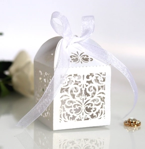 Elegant white laser-cut wedding candy box with ribbon bow and European floral pattern