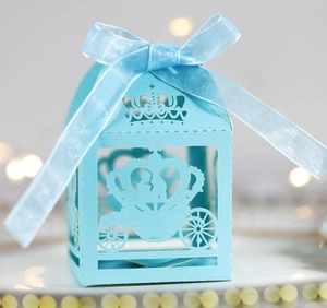 Detail of laser-cut crown and carriage pattern on light blue hollow wedding candy box