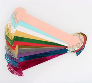 Close-up of laser-cut lace napkin rings in various vibrant colors for wedding decor