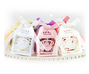 Laser cut hollow wedding favor boxes with crown and carriage motifs and sheer ribbons