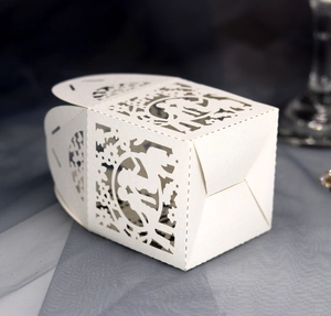 Elegant laser cut pearl white wedding candy box featuring a bride and groom hollow design