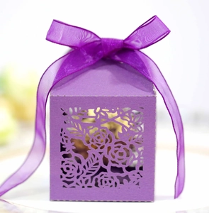 Detail showing laser-cut rose patterns and purple organza ribbon on square gift box