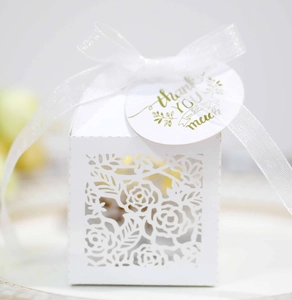 Detailed laser-cut white gift box with rose patterns, silk ribbon and thank you tag