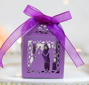 Laser-cut purple wedding favor box with silhouette engraving and satin ribbon