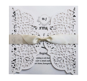Elegant laser-cut wedding invitation card with lace floral design and satin ribbon bow