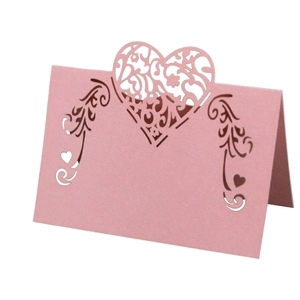 Pink laser-cut heart place card for weddings with romantic vine patterns and cardstock