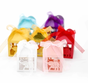 Detailed laser-cut elephant pattern on colorful paper favor boxes with ribbon bows