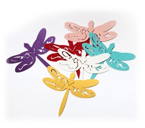 Close-up of laser-cut dragonfly paper place cards with glitter finish in six colors