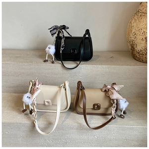 Close-up of premium leather crossbody bags in black, beige, and khaki with silk scarves