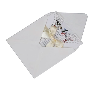 Invitation de mariage blanche découpée au laser avec ruban crème et carte fleurie