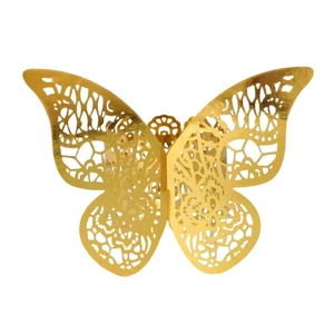 Macro detail of gold laser-cut butterfly napkin ring with hollow floral pattern