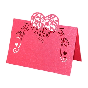 Detail of pink glitter laser cut heart table card with floral hollow pattern