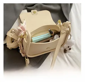 Detail view of the mini square bag interior showing compartments for cosmetics
