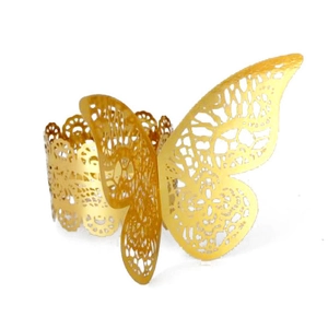 Detail of laser-cut gold butterfly napkin ring with intricate hollow lace patterns