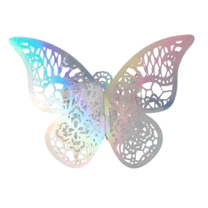 Macro detail of laser-cut butterfly napkin ring with iridescent hollow lace texture