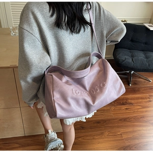 Close-up of purple tote bag with love 105°C embossed texture and wide shoulder strap
