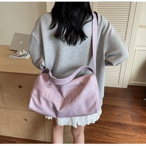 Detail of lavender tote bag with embossed love 105 text and comfortable wide shoulder strap