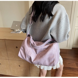 Detail view of light purple large tote bag with love 105 embossed lettering and wide strap