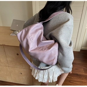 Detailed view of lavender leather tote bag with 3D LOVE 105C embossed lettering and strap