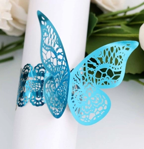 Detail of laser-cut butterfly napkin ring in bright blue with intricate hollow patterns