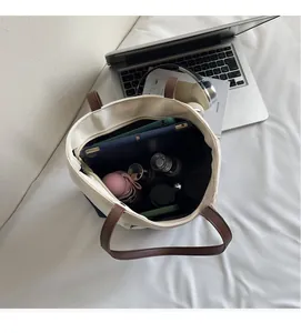 Top view of large canvas tote bag showing spacious interior with tablet and umbrella
