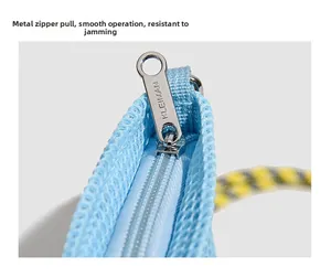 Close-up of smooth silver zipper pull on light blue mesh bag with woven cord detail