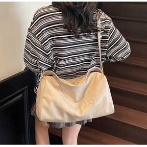 Detail view of beige leather tote bag with 105°C embossed logo on the shoulder strap