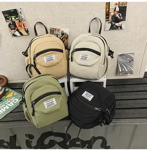 Mini nylon backpacks in khaki, beige, green, and black with Chuangmi labels on a display shelf