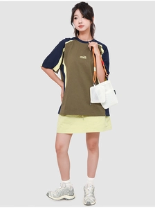 Detail of white mesh shoulder bag with orange adjustable drawstring and functional design