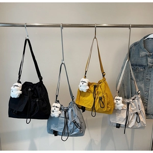 Detailed collection of textured nylon drawstring crossbody bags in four soft colors