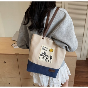 Detail of canvas tote bag featuring contrast colors and artistic illustration print