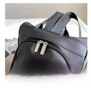 Detail of premium black nylon backpack featuring smooth dual silver metal zippers and straps