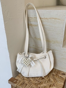 Creamy white oversized faux leather shoulder bag with a pearl heart charm and lace bow