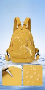 Close-up showing the waterproof and scratch-resistant yellow nylon fabric of the backpack