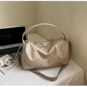Detail of beige large capacity tote bag with love 105°c embossed design and strap
