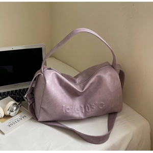 Macro detail of lavender tote bag with embossed lettering on high quality faux leather