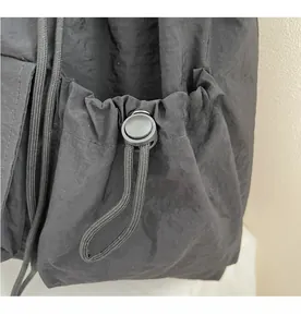 Detail shot of black drawstring closure with durable nylon fabric and plastic toggle