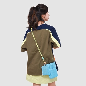 Model wearing light blue mesh crossbody bag with rope strap and small square pouch