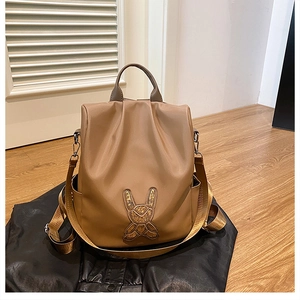 Detail of coffee brown nylon backpack with sparkling rabbit motif and adjustable straps