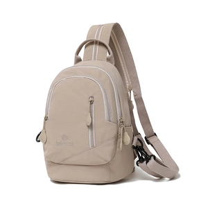 Detail view of khaki nylon crossbody bag featuring metallic hardware and MSSHUIA logo
