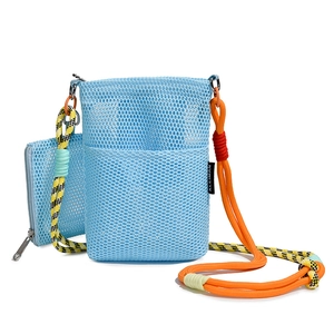 Detail of blue mesh crossbody bag featuring colorful climbing rope straps and brand tag
