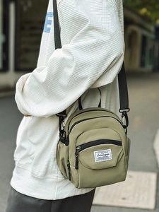 Olive green nylon crossbody bag with adjustable strap and front zipper pocket for women