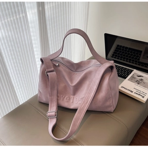 Close-up of pink oversized Boston bag featuring love 105 embossed logo on leather