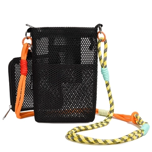 Close-up of black mesh crossbody bag with colorful woven rope strap and brand tag