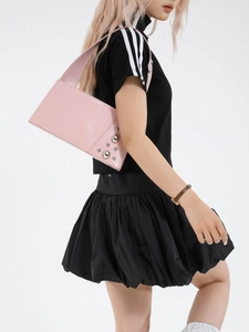 Pink rectangular patent leather shoulder bag with silver rivet studs on model