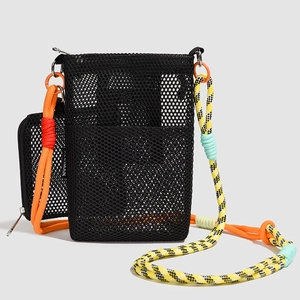 Detail of black mesh crossbody bag with colorful climbing rope strap and a small coin pouch
